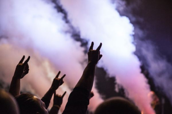 photo of persons doing rock hand sign photo of persons doing rock hand sign