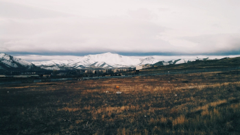 Photo of Snow Capped Mountains Near Grass Photo of Snow Capped Mountains Near Grass