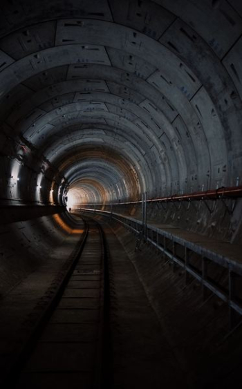 photo of train rail tunnel photo of train rail tunnel