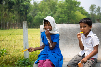 Photo of Two Children Eating Food Photo of Two Children Eating Food