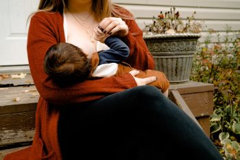 Photo Of Woman Breastfeeding Her Child Photo Of Woman Breastfeeding Her Child