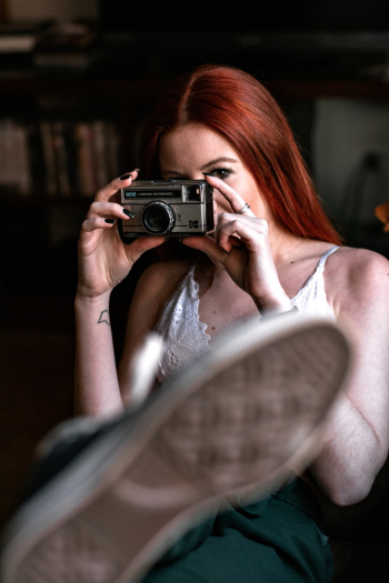 Photo of Woman Holding an Old Camera Photo of Woman Holding an Old Camera