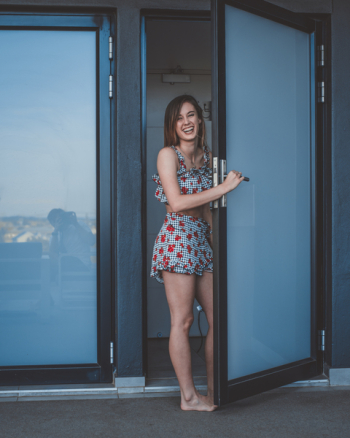 Photo of Woman Opening Door Photo of Woman Opening Door