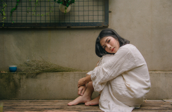 Photo of Woman Sitting Down on Floor Photo of Woman Sitting Down on Floor