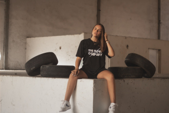 Photo Of Woman Sitting Near Tires Photo Of Woman Sitting Near Tires