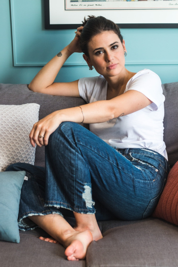 Photo of Woman Sitting On Couch Photo of Woman Sitting On Couch