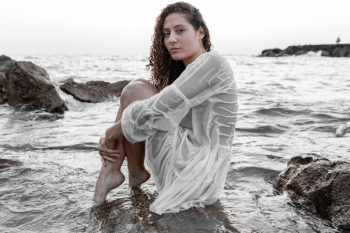 Photo of Woman Sitting On Rock Photo of Woman Sitting On Rock