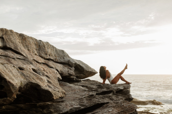Photo Of Woman Sitting On Rock