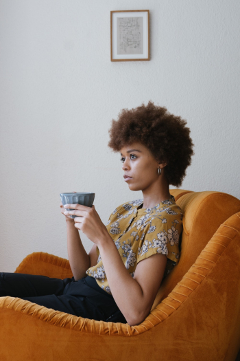 Photo Of Woman Sitting On Sofa Photo Of Woman Sitting On Sofa