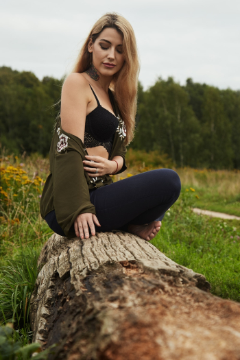 Photo Of Woman Sitting On Wooden Log Photo Of Woman Sitting On Wooden Log
