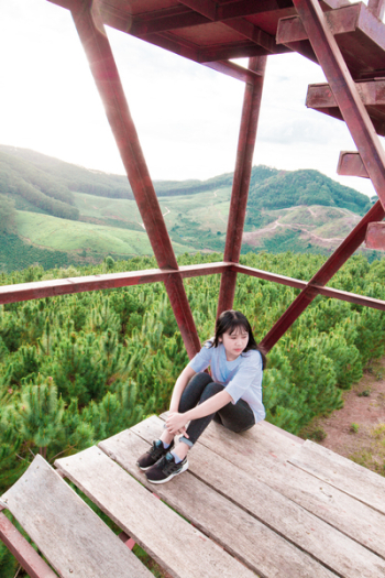 Photo of Woman Sitting On Wooden Platform Photo of Woman Sitting On Wooden Platform