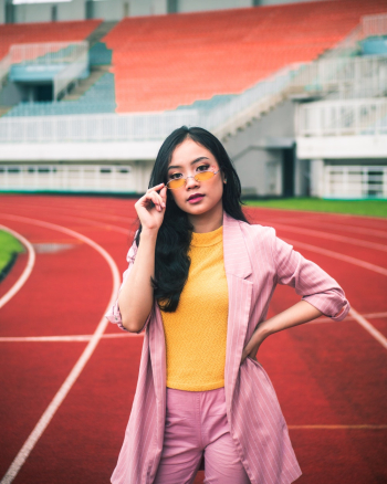 Photo of Woman Standing in Athletic Field