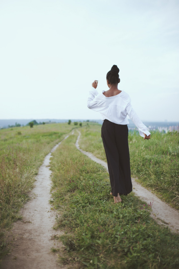 Photo of Woman Walking On Grass Photo of Woman Walking On Grass