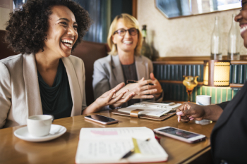 Photo of Women Laughing During Business Meeting. Photo of Women Laughing During Business Meeting.