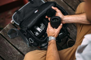 Photographer holding a DSLR camera Photographer holding a DSLR camera
