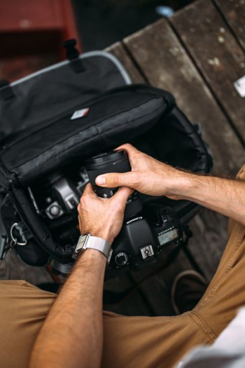 Photographer holding a DSLR camera Photographer holding a DSLR camera