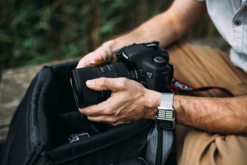 Photographer holding a DSLR camera Photographer holding a DSLR camera