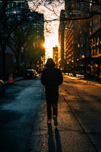 Photography of Person Walking On Road Photography of Person Walking On Road