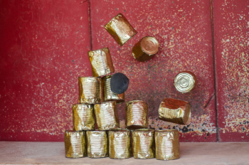 Pile Brass-colored Cans on Beige Surface Pile Brass-colored Cans on Beige Surface