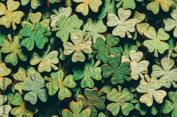 Pile of wooden green four-leaf clovers