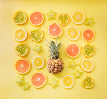 pineapple surrounded by citrus fruits pineapple surrounded by citrus fruits