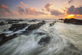 Pink Cloudy Sunset over Rocky Ocean Pink Cloudy Sunset over Rocky Ocean