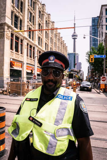Policeman Standing on Street Near Buildings