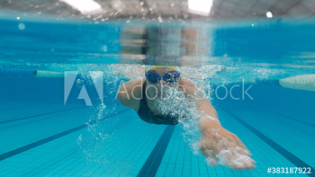 Portrait athletic female swimmer swimming underwater