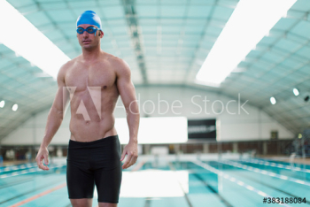 Portrait athletic male swimmer at indoors swimming pool