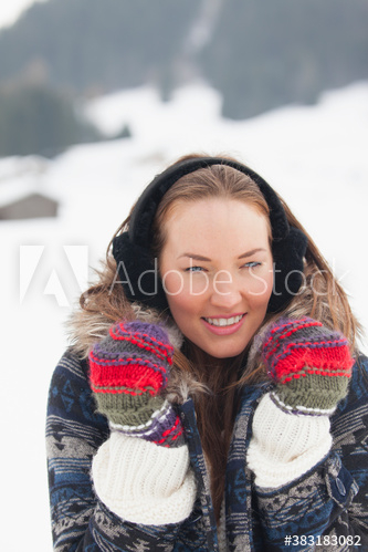 Portrait beautiful young woman in warm clothing in snow Portrait beautiful young woman in warm clothing in snow