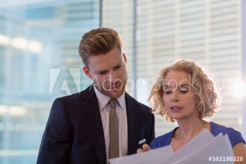 Portrait business people discussing paperwork Portrait business people discussing paperwork