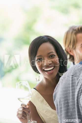 Portrait carefree young woman drinking white wine with friends
