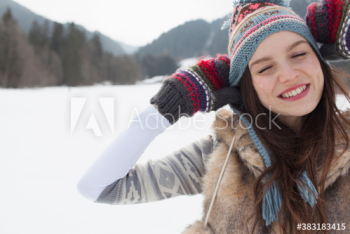 Portrait carefree young woman in snowy field