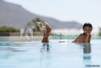 Portrait carefree young woman laying in swimming pool
