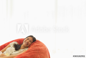 Portrait carefree young woman relaxing in beanbag chair