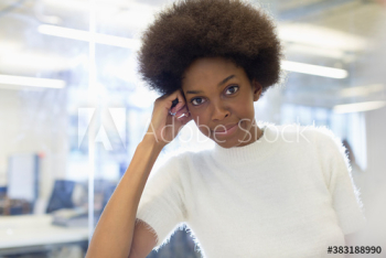 Portrait confident beautiful young businesswoman with afro in office Portrait confident beautiful young businesswoman with afro in office