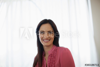 Portrait confident brunette woman at window Portrait confident brunette woman at window
