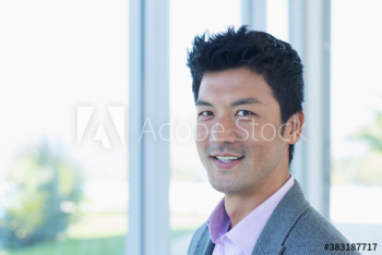 Portrait confident businessman at window Portrait confident businessman at window