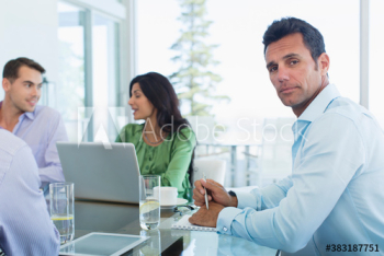 Portrait confident businessman in meeting Portrait confident businessman in meeting
