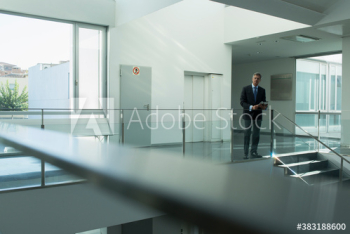 Portrait confident businessman in office corridor Portrait confident businessman in office corridor