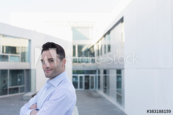 Portrait confident businessman on office balcony Portrait confident businessman on office balcony