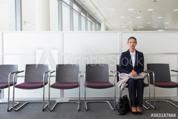 Portrait confident businesswoman waiting for job interview in lobby Portrait confident businesswoman waiting for job interview in lobby