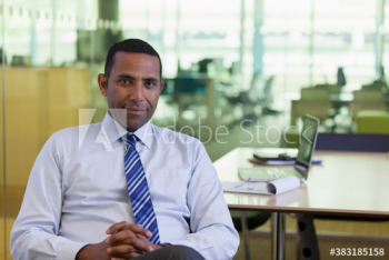 Portrait confident corporate businessman in office Portrait confident corporate businessman in office