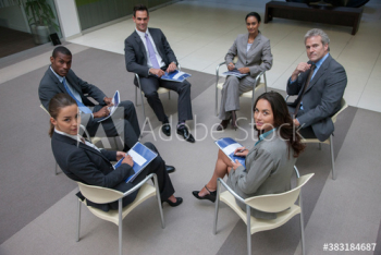Portrait confident diverse corporate business people meeting in circle Portrait confident diverse corporate business people meeting in circle