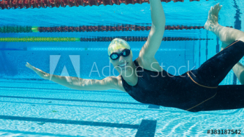 Portrait confident female swimmer underwater Portrait confident female swimmer underwater