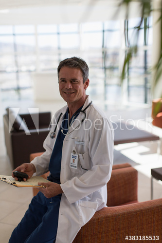 Portrait confident male doctor in hospital lobby Portrait confident male doctor in hospital lobby