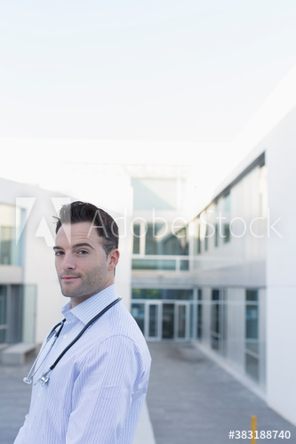 Portrait confident male doctor on hospital balcony Portrait confident male doctor on hospital balcony