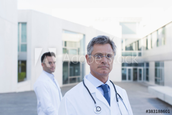 Portrait confident male doctors on hospital balcony Portrait confident male doctors on hospital balcony