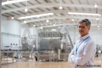 Portrait confident male manager supervising factory floor Portrait confident male manager supervising factory floor