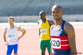 Portrait confident male track and field athletes sunny running track Portrait confident male track and field athletes sunny running track
